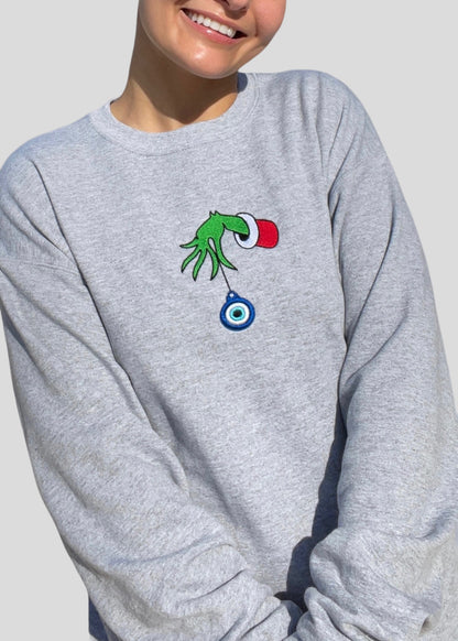 Embroidered Grinch Hand with Evil Eye Ornament Sweatshirts