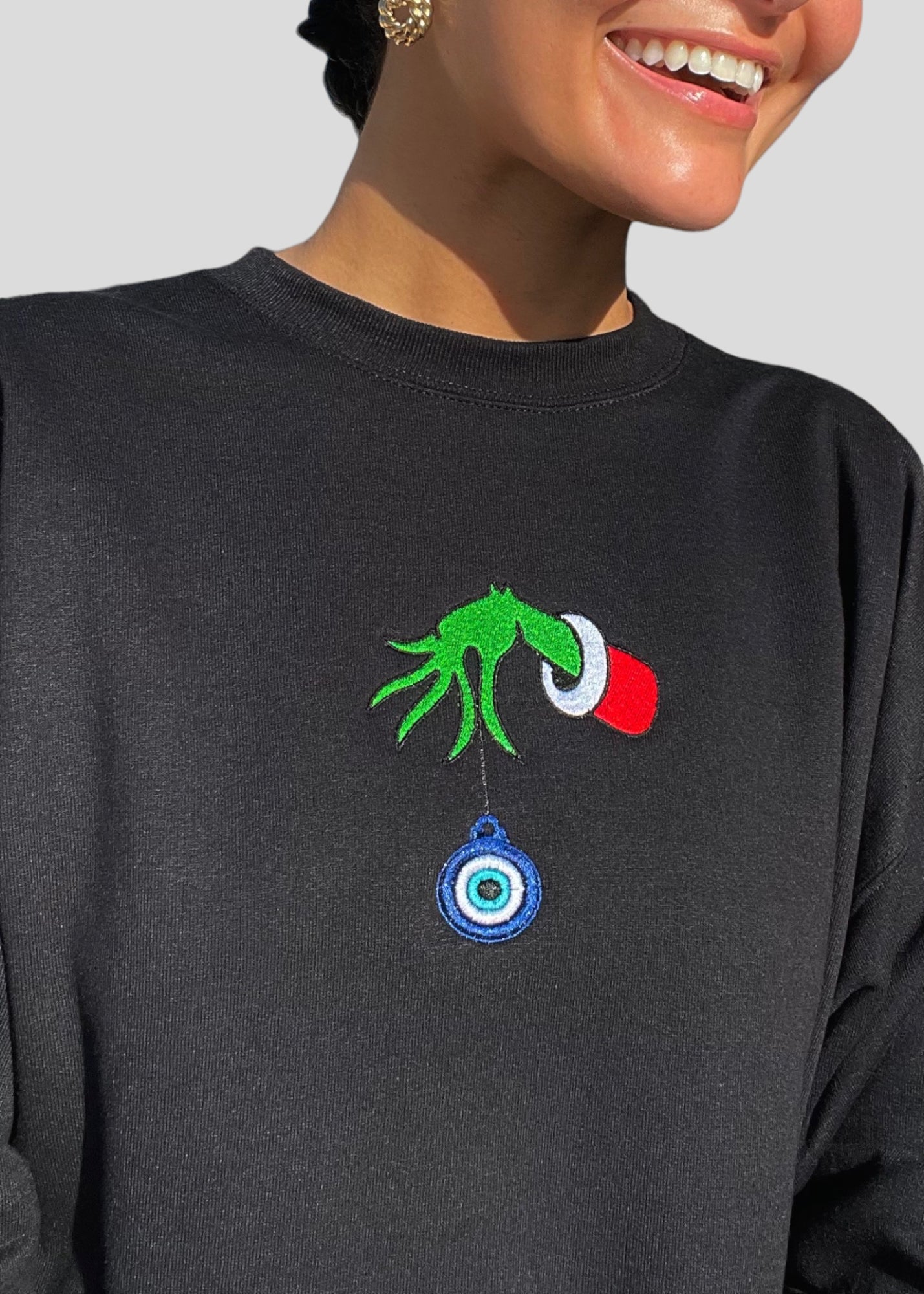 Embroidered Grinch Hand with Evil Eye Ornament Sweatshirts